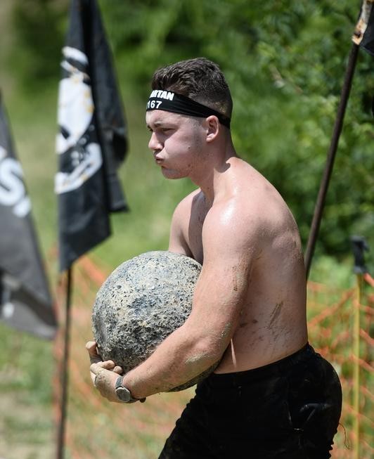 Ethan Bible carrying a stone during a Spartan race
